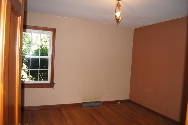 unfurnished room featuring dark hardwood / wood-style floors