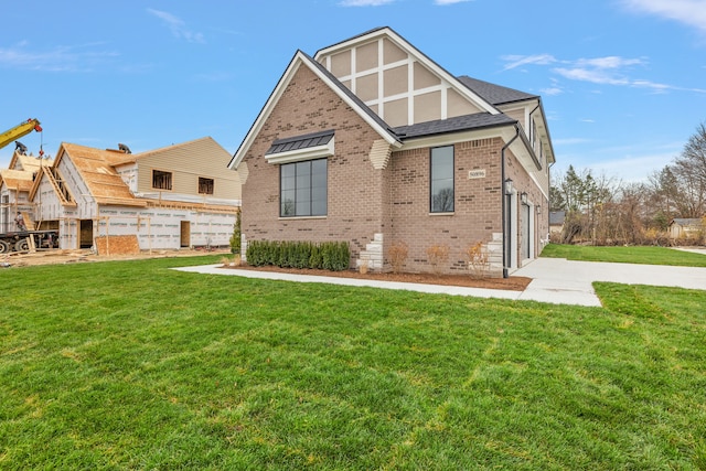 back of house featuring a lawn and a garage