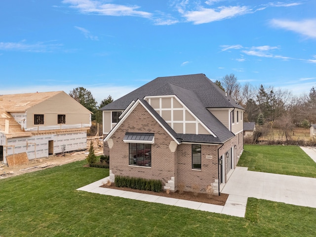 back of property with a lawn and a patio