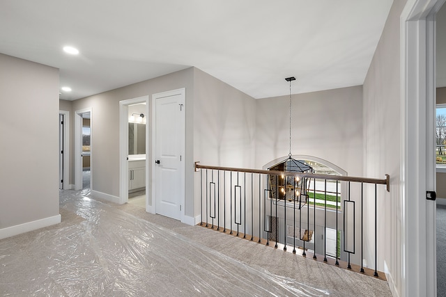 hall featuring an inviting chandelier and a wealth of natural light