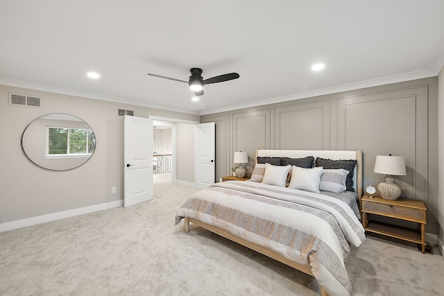 carpeted bedroom with ceiling fan and crown molding