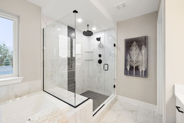 bathroom featuring separate shower and tub and a wealth of natural light