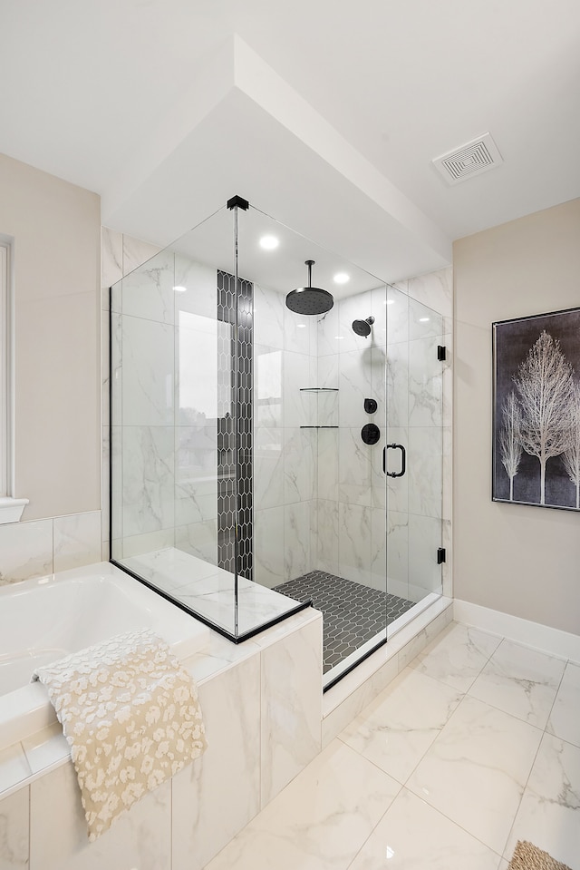 bathroom featuring shower with separate bathtub