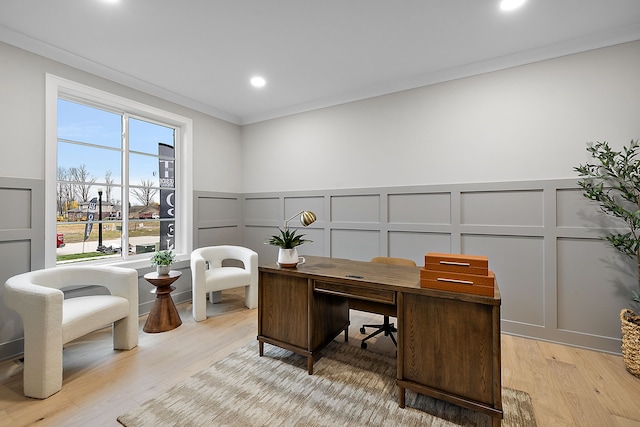 home office with light wood-type flooring and ornamental molding