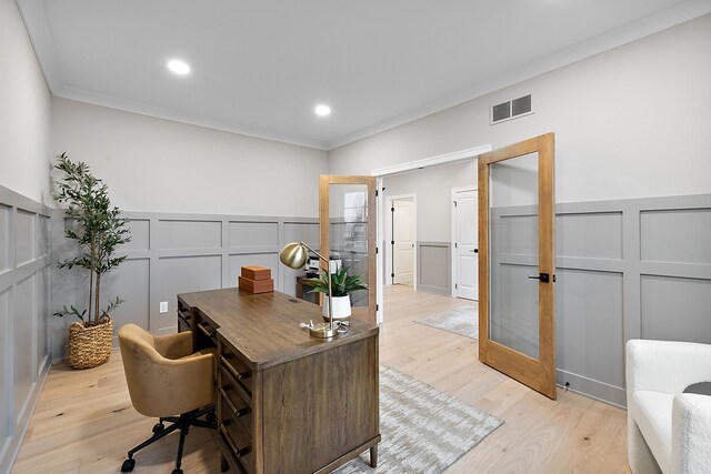 office with ornamental molding, french doors, and light hardwood / wood-style flooring