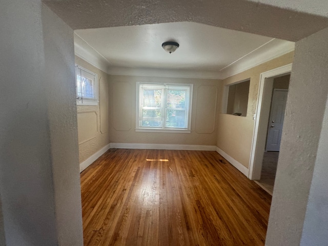 empty room with hardwood / wood-style floors and a wealth of natural light