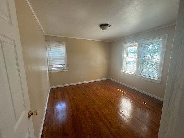 spare room featuring hardwood / wood-style floors and ornamental molding