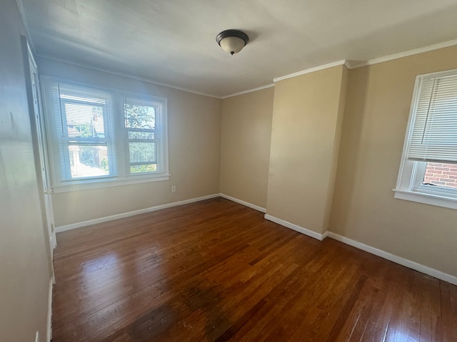 empty room featuring crown molding and dark hardwood / wood-style floors