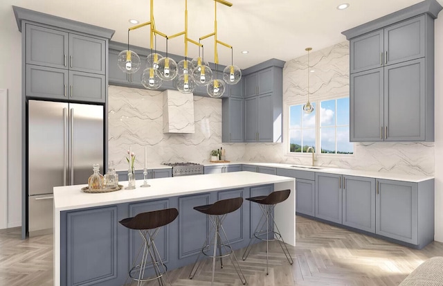 kitchen featuring gray cabinetry, a kitchen breakfast bar, parquet flooring, and high quality fridge