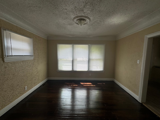 spare room featuring a textured ceiling, dark hardwood / wood-style flooring, and crown molding