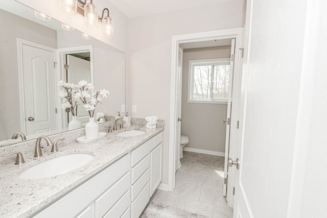 bathroom featuring vanity and toilet