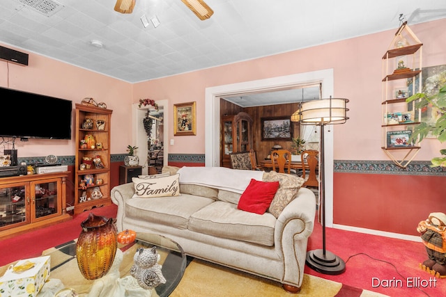 living room with ceiling fan and visible vents