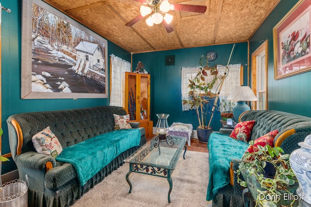 living area featuring carpet and a ceiling fan