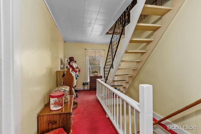 hall with carpet and stairway