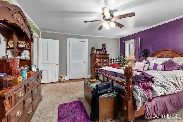 bedroom with carpet flooring, crown molding, and ceiling fan