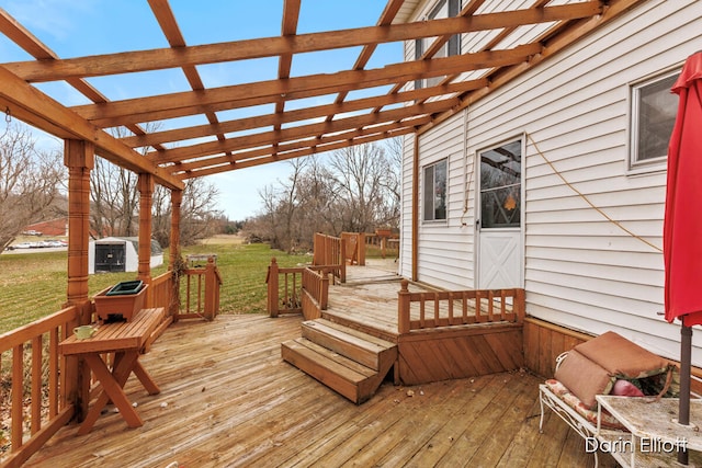 wooden terrace featuring a lawn and a pergola