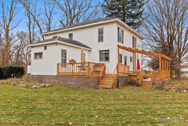 rear view of property with a deck and a yard