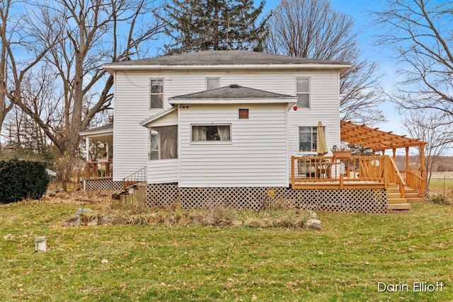 rear view of property featuring a lawn and a wooden deck