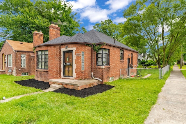 rear view of property featuring a lawn