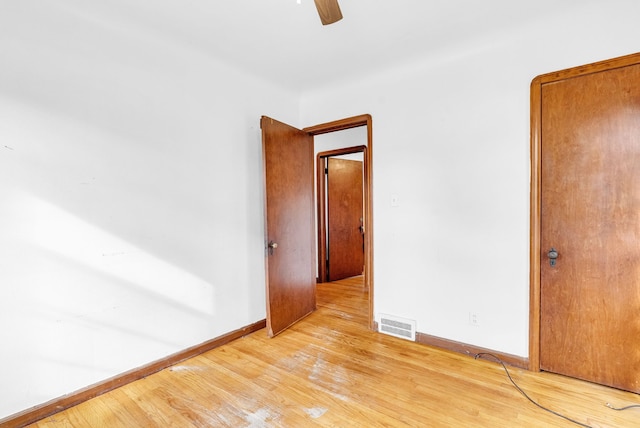 empty room featuring ceiling fan and light wood-type flooring