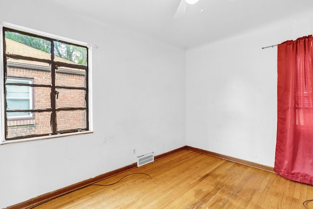 unfurnished room featuring hardwood / wood-style flooring and ceiling fan