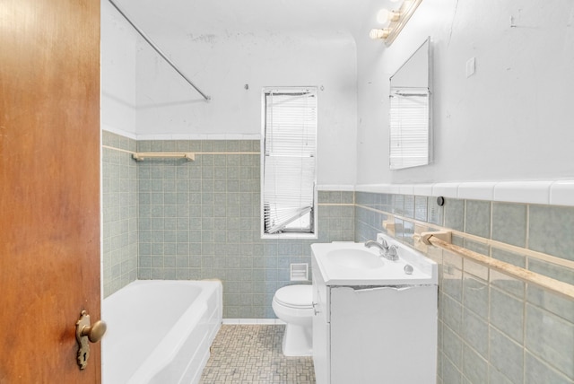 full bathroom featuring tile patterned floors, vanity, shower / washtub combination, tile walls, and toilet