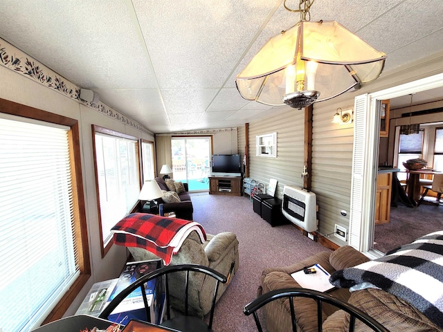 831 S Main St, Au Gres, MI 48703 - carpeted living room featuring heating unit and a drop ceiling