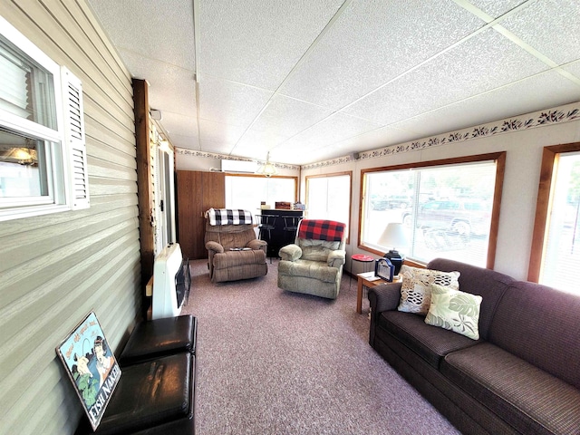 831 S Main St, Au Gres, MI 48703 - sunroom with an outdoor hangout area, carpet flooring, wood walls, healthy amount of natural light, and a drop ceiling