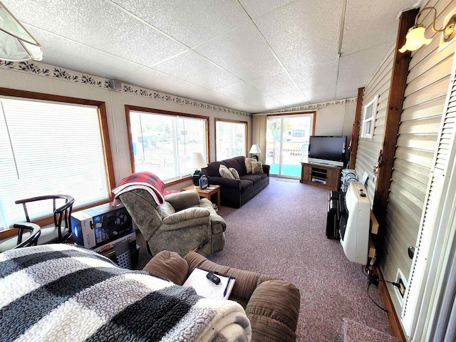 831 S Main St, Au Gres, MI 48703 - carpeted living room featuring a drop ceiling