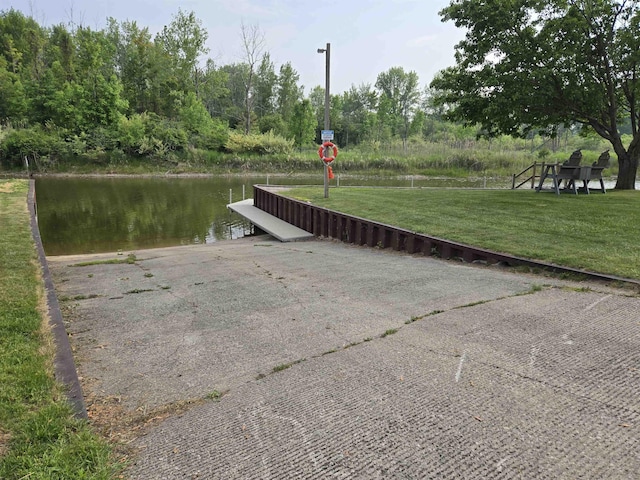 831 S Main St, Au Gres, MI 48703 - dock area with a boat ramp, a water view, and a lawn