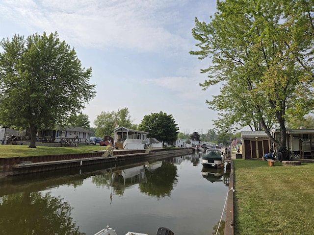 831 S Main St, Au Gres, MI 48703 - dock featuring a water view and a lawn