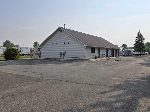 831 S Main St, Au Gres, MI 48703 - view of side of home featuring uncovered parking