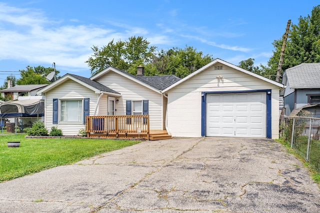 single story home featuring a front lawn, a deck, and a garage