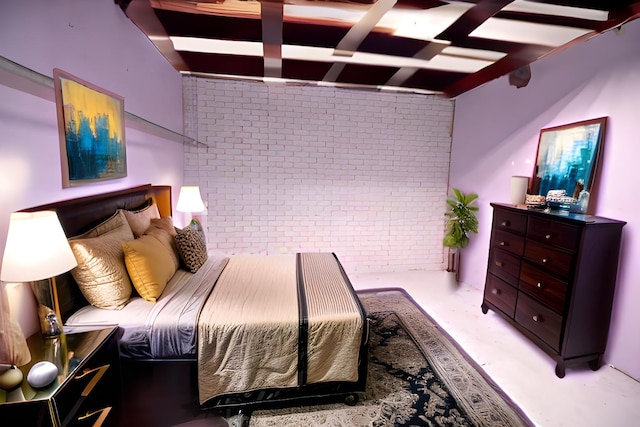 bedroom featuring brick wall