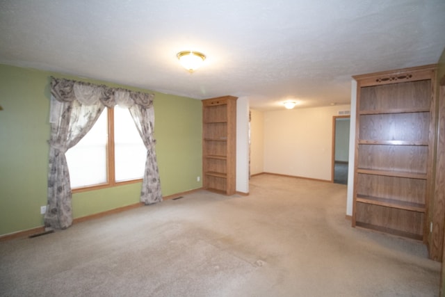 unfurnished room with light carpet