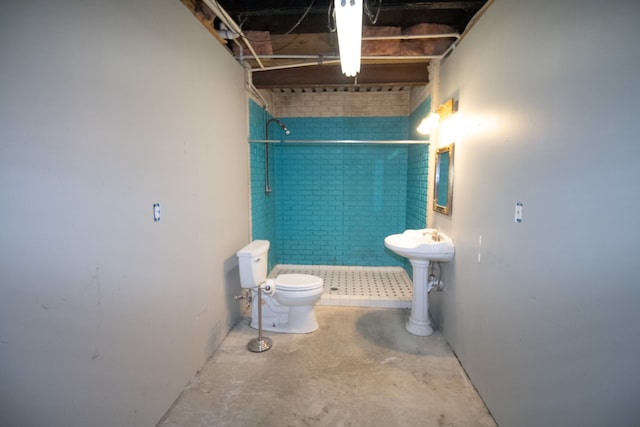 bathroom with sink, concrete floors, a shower, and toilet