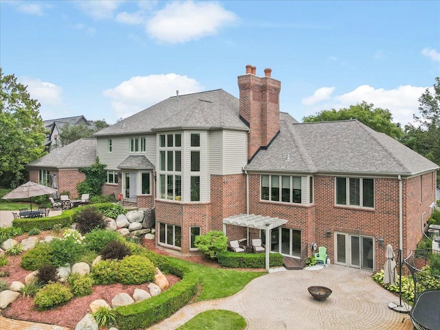 back of property featuring a pergola and a patio