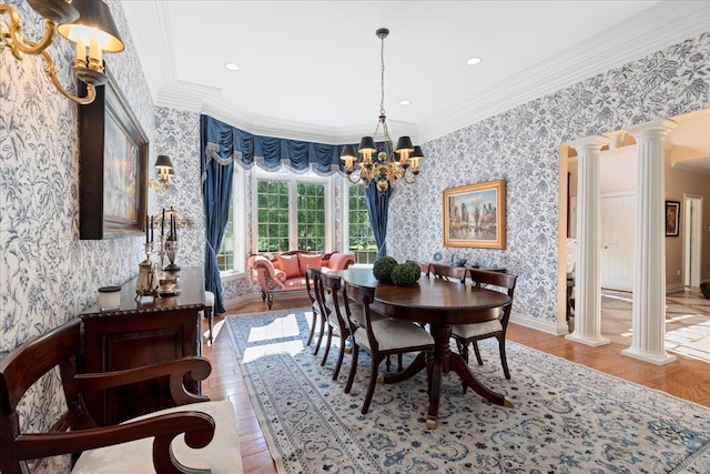 dining space with hardwood / wood-style floors, ornate columns, and ornamental molding