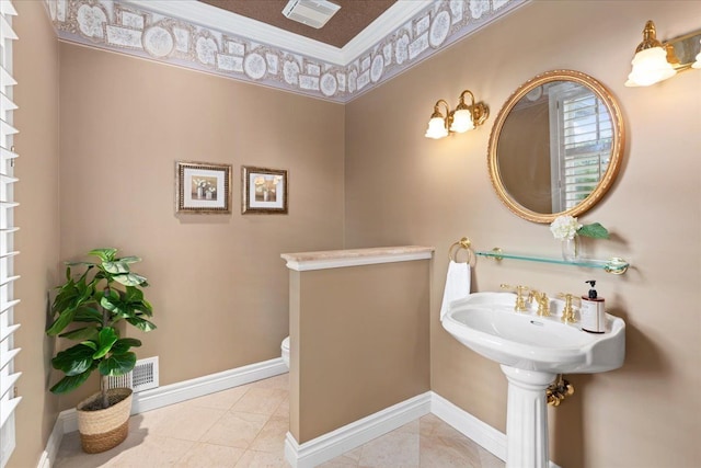 bathroom featuring tile patterned floors, crown molding, and toilet