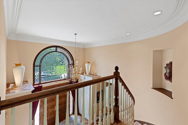 hall featuring a chandelier and crown molding