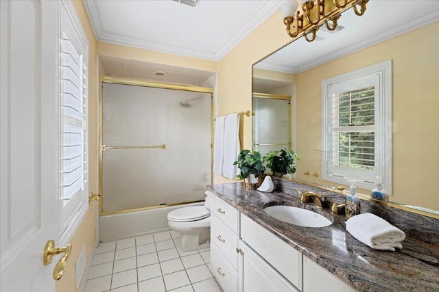 full bathroom featuring vanity, tile patterned floors, crown molding, toilet, and enclosed tub / shower combo