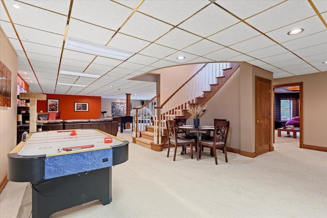 recreation room featuring carpet and a drop ceiling