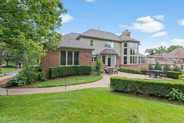 view of front of house with a patio and a front lawn