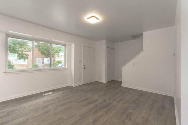 empty room with dark wood-type flooring