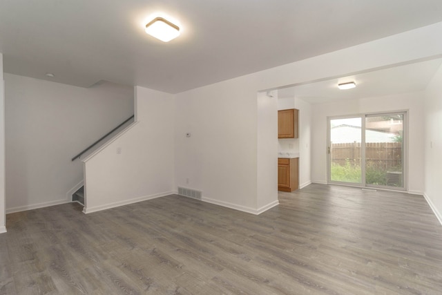 unfurnished living room featuring dark hardwood / wood-style floors