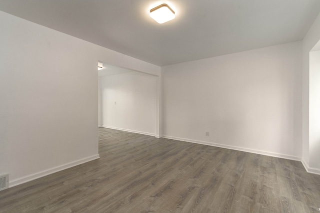 unfurnished room featuring dark hardwood / wood-style flooring