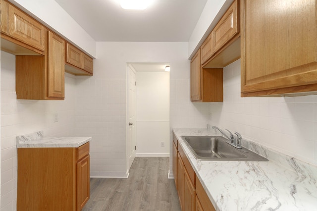 kitchen with sink and light wood-type flooring