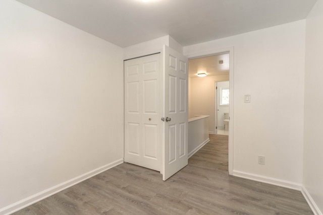 spare room featuring wood-type flooring