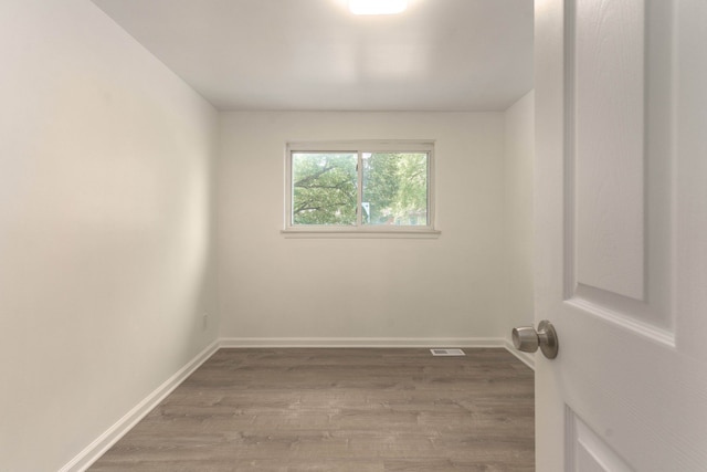 empty room with hardwood / wood-style floors