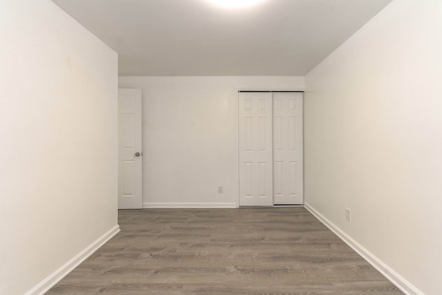 unfurnished bedroom featuring hardwood / wood-style flooring and a closet